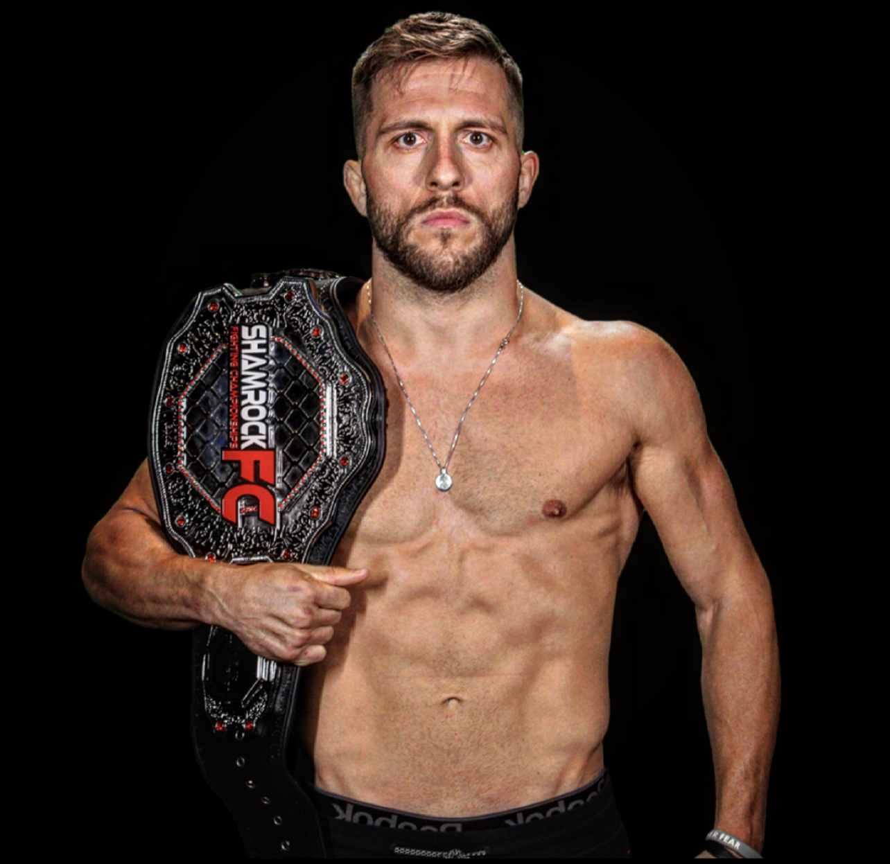 Dustin Lampros with the Shamrock FC championship belt